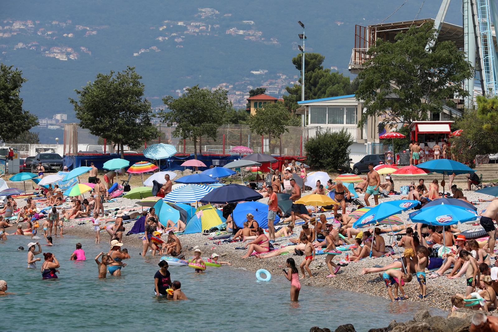 09.07.2024., Rijeka - Guzva na gradskoj plazi Kantrida. rijecani i njihovi gosti pokusavaju se rashladiti u moru, a od sunca se stite suncobranima.  Photo: Goran Kovacic/PIXSELL