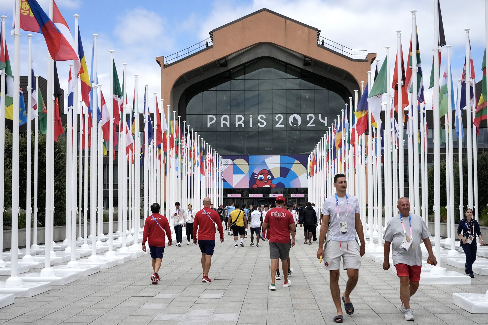 epa11491300 People walk in front of the Olympic village canteen for the Paris 2024 Olympic Games, in Paris, France, 22 July 2024.  EPA/MICHEL EULER / POOL MAXPPP OUT