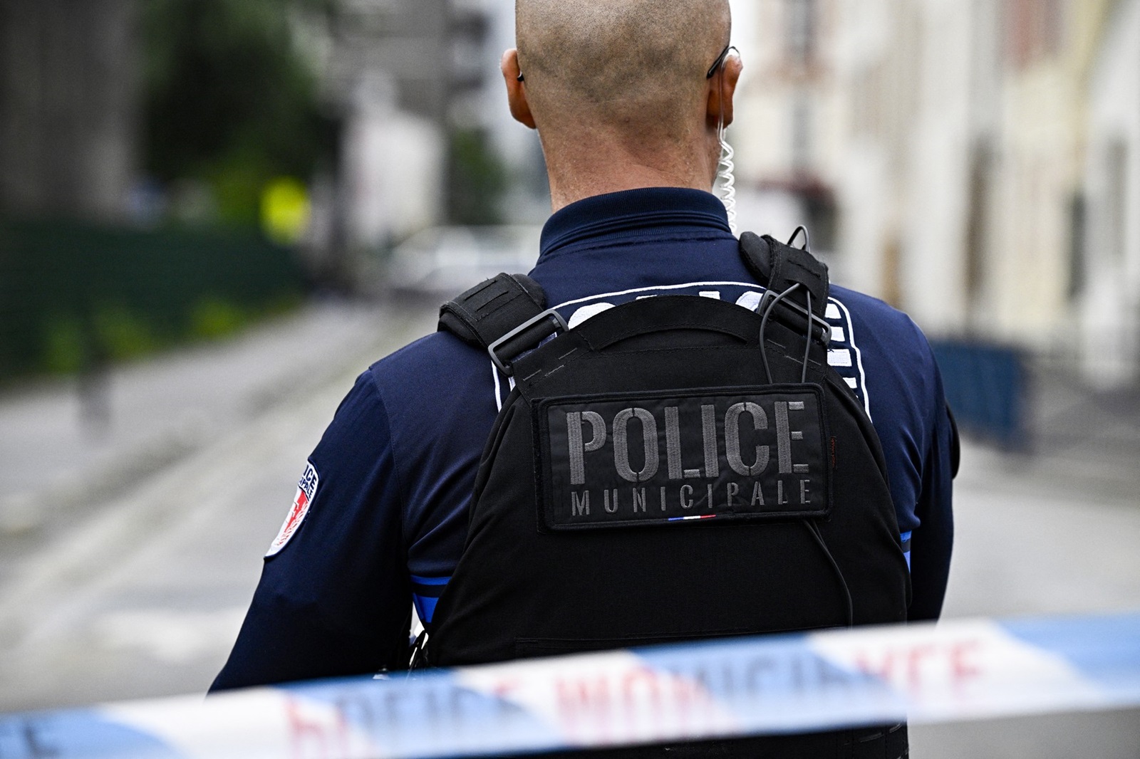 A municipal police officer stands near a crime scene after a man was shot dead by the municipal police after the attack with a screwdriver on a cleaning agent, in Aubervilliers near Paris, on June 19, 2024. A man was shot dead on June 19, 2024, morning in Aubervilliers by the municipal police after the attack with a screwdriver on a cleaning agent, AFP learned from police sources. During this attack which occurred around 7:30 a.m., a worker and a police officer were injured but their life-threatening condition is not in jeopardy. The author was then killed by a municipal police officer who used his weapon twice, according to one of the sources.,Image: 882922774, License: Rights-managed, Restrictions: , Model Release: no, Credit line: JULIEN DE ROSA / AFP / Profimedia