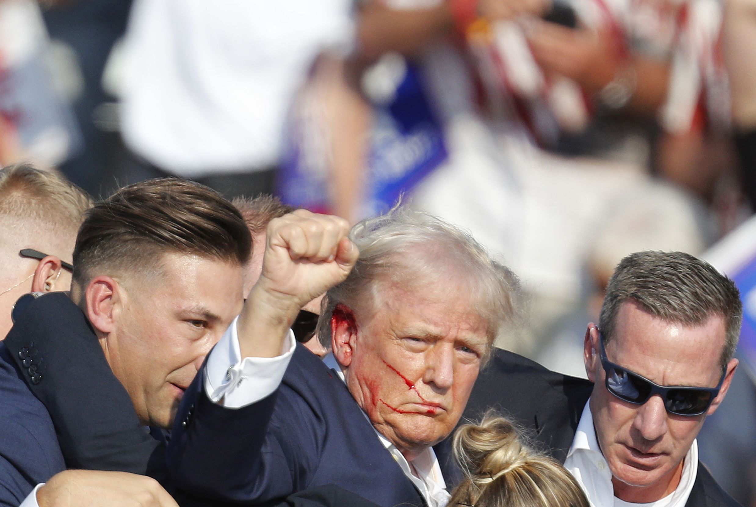 epa11476744 Former US President Donald Trump is rushed off stage by secret service after an incident during a campaign rally at the Butler Farm Show Inc. in Butler, Pennsylvania, USA, 13 July 2024.  EPA/DAVID MAXWELL