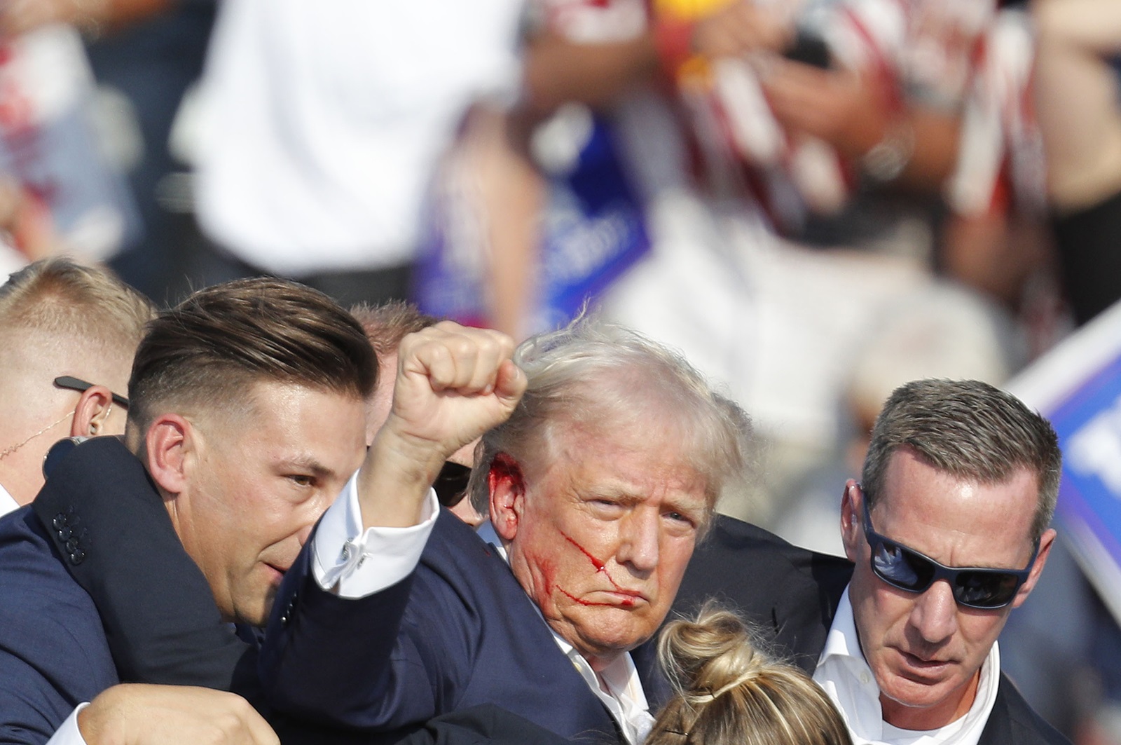 epa11476744 Former US President Donald Trump is rushed off stage by secret service after an incident during a campaign rally at the Butler Farm Show Inc. in Butler, Pennsylvania, USA, 13 July 2024.  EPA/DAVID MAXWELL