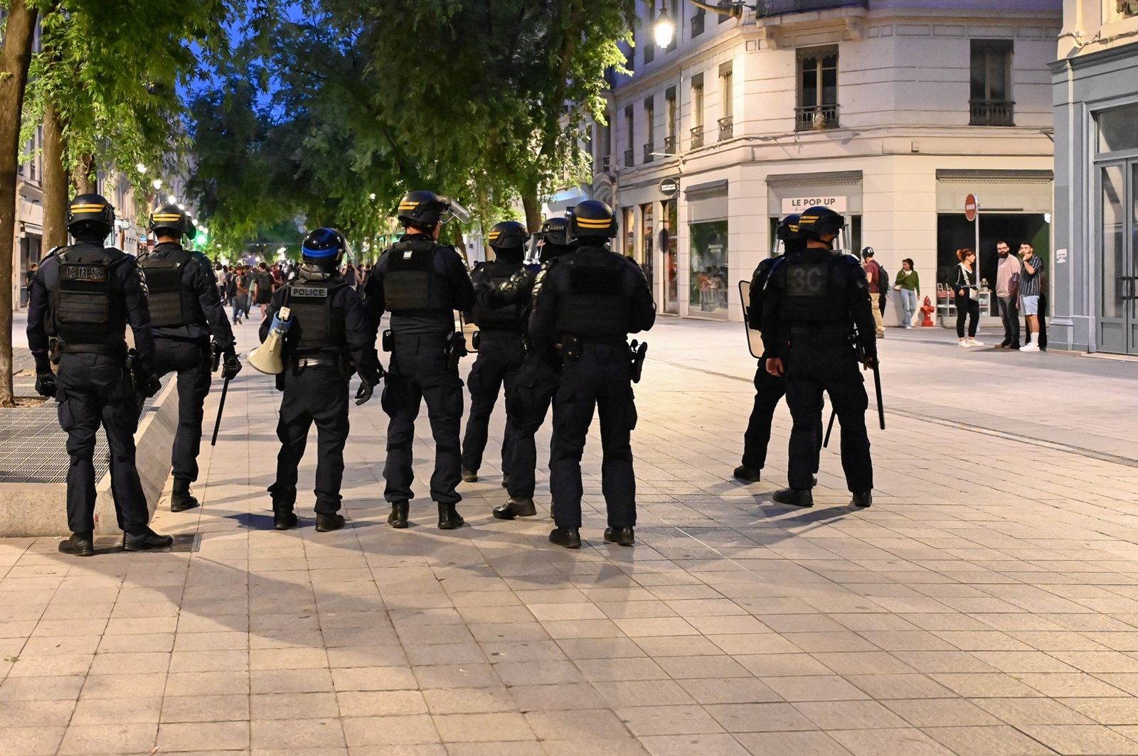 A company of CRS and a member of the National Police are grouped together in the Republic street during a wild demonstration in reaction to the results of the June 30 legislative elections and against the far right, in Lyon, France, June 30, 2024.,Image: 886255248, License: Rights-managed, Restrictions: , Model Release: no, Credit line: Matthieu Delaty / AFP / Profimedia