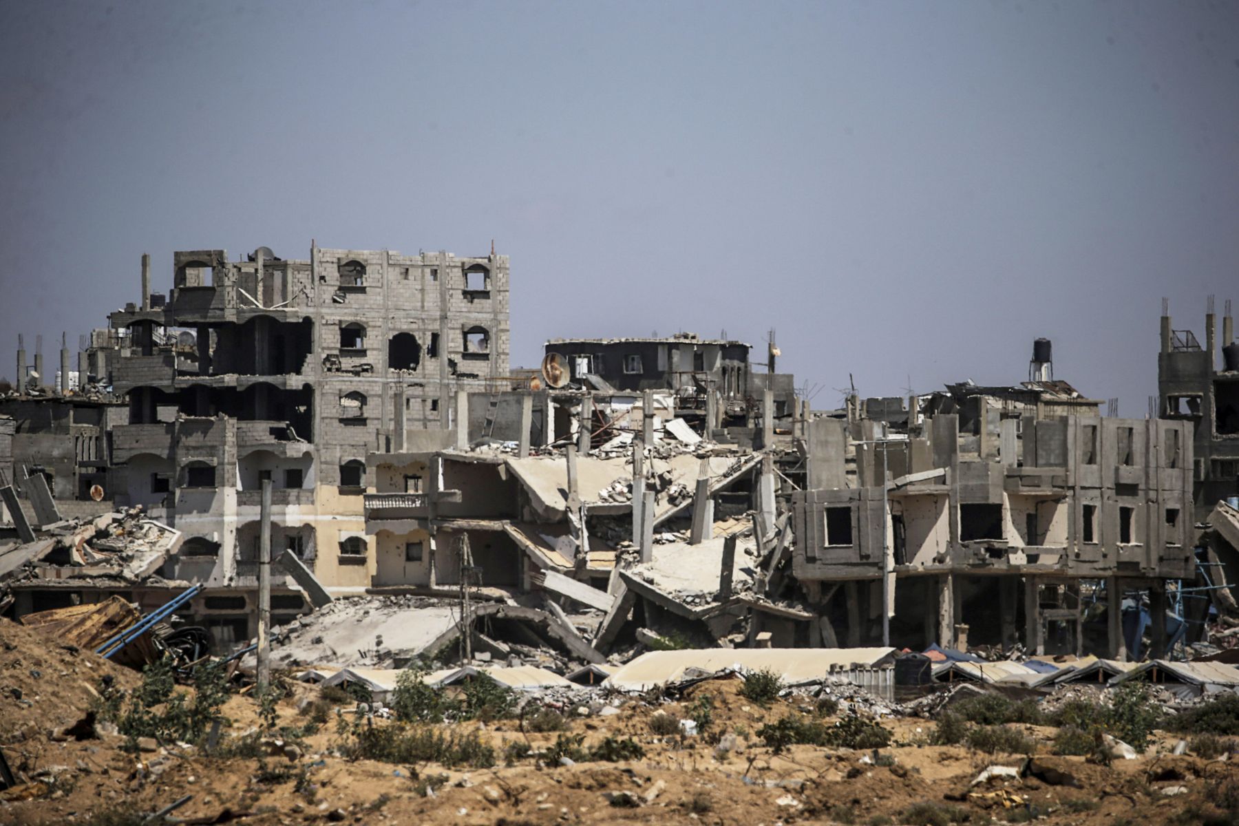 epa11506093 Destroyed structures as Palestinians flee from Al Bureije refugee camp after a new evacuation order was issued by the Israel Defense Forces (IDF) for Al Bureije and Al Nusairat camps in the central Gaza Strip, 29 July 2024. More than 39,000 Palestinians and over 1,400 Israelis have been killed, according to the Palestinian Health Ministry and the Israel Defense Forces (IDF), since Hamas militants launched an attack against Israel from the Gaza Strip on 07 October 2023, and the Israeli operations in Gaza and the West Bank which followed it.  EPA/MOHAMMED SABER