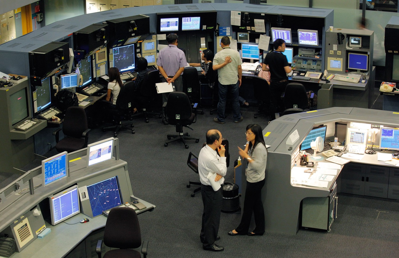 TO GO WITH Aviation-IT-Internet-security FEATURE by Adrian Addison 
In a picture taken on October 13, 2010 Air Traffic Controllers monitor flight traffic in the control tower of Hong Kong international airport. Around the world, around the clock, circles of flickering screens keep aircraft apart in the air, ease them gently down to the ground and guide them and their precious human cargoes off the runway. This finely choreographed global ballet of speeding metal, flesh and fuel transported almost five billion passengers in 2009, according to data from Airports Council International. But what if all those screens went blank?,Image: 85535425, License: Rights-managed, Restrictions: TO GO WITH Aviation-IT-Internet-security FEATURE by Adrian Addison, Model Release: no, Credit line: Ed Jones / AFP / Profimedia