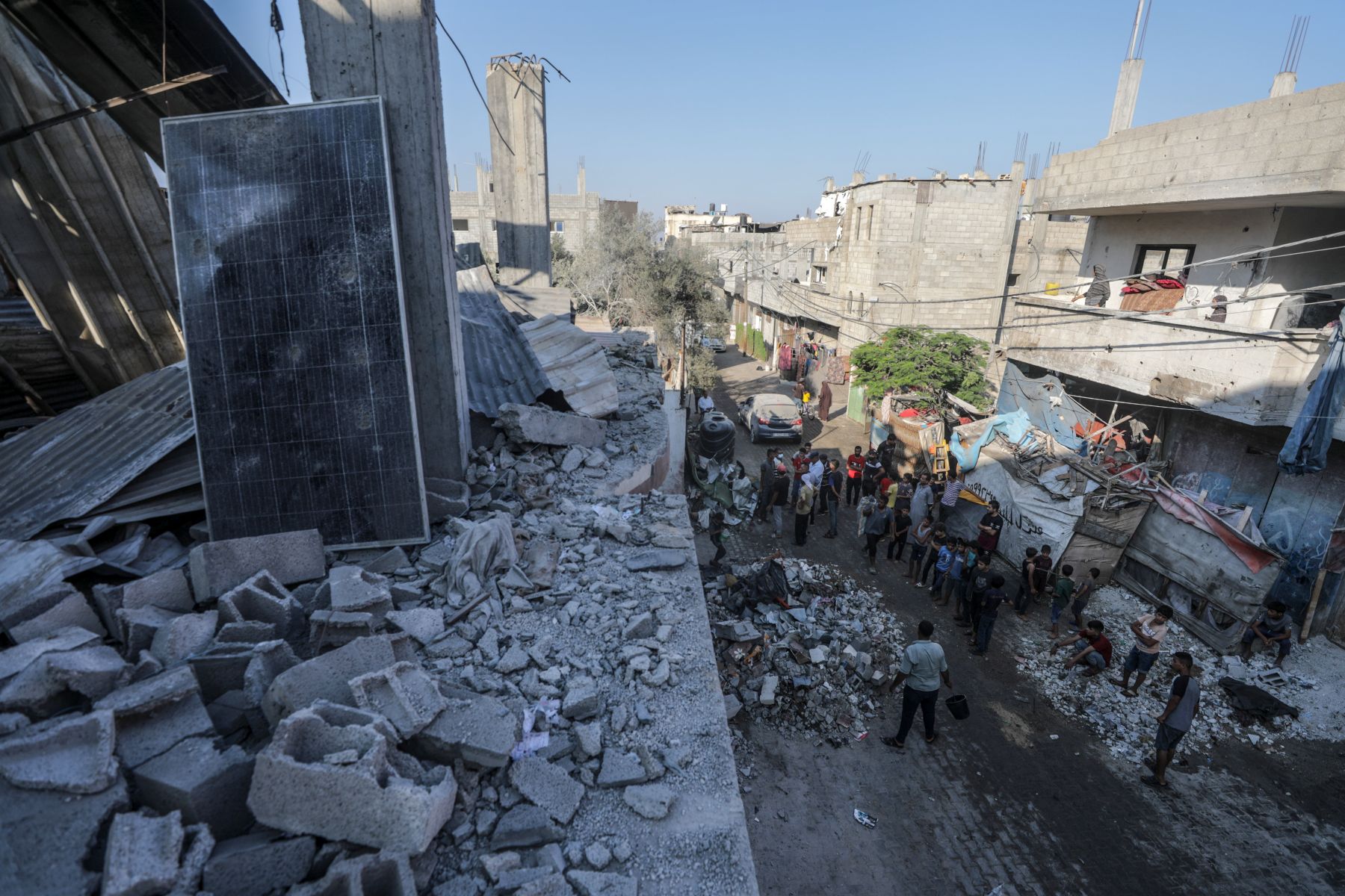 epa11484878 Palestinians inspect the destroyed home of the Muheisen family following an Israeli air strike in the Al Zwaida neighbourhood in the central Gaza Strip, 18 July 2024. According to a report from the Ministry of Health in Gaza, six Palestinians, members of the Muheisen family, were killed following an Israeli air strike in the Central Gaza Strip. More than 38,000 Palestinians and over 1,400 Israelis have been killed, according to the Palestinian Health Ministry and the Israel Defense Forces (IDF), since Hamas militants launched an attack against Israel from the Gaza Strip on 07 October 2023, and the Israeli operations in Gaza and the West Bank which followed it.  EPA/MOHAMMED SABER