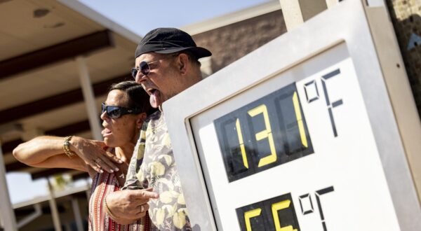 Visitors pose next to a thermometer reading 131 degrees Fahrenheit and 55 degrees Celsius at the Visitor Center in Death Valley National Park, near Furnace Creek, during a heatwave impacting Southern California on July 7, 2024. Temperatures in Death Valley could reach as high as 130 degrees Farenheit (54 degrees Celsius) on Sunday, according to US National Weather Service.,Image: 888106463, License: Rights-managed, Restrictions: , Model Release: no, Credit line: ETIENNE LAURENT / AFP / Profimedia