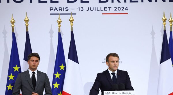 epa11476406 French President Emmanuel Macron (R), accompanied by French Prime Minister Gabriel Attal, gives a speech to the French Military Forces at the Hotel de Brienne in Paris, France, 13 July 2024, on the eve of Bastille Day, the French national day.  EPA/STEPHANIE LECOCQ / POOL MAXPPP OUT