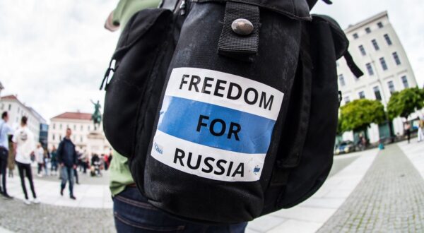 May 9, 2023, Munich, Bavaria, Germany: Members of the Russian opposition hold signs with the victims of russia's war, as well as stickers demanding freedom for Russia. Coinciding with worldwide Victory Day celebrations, Munich saw another Immortal Regiment demo that was this time led by Amid Saidi, who organized the putinist demo in 2022. Originally conceived by Russian journalists Sergei Kolotovkin, Sergei Lapenkov, and Igor Dmitriev, to have non-militarized commemorations of those who fought in WWII, the Immortal Regiment (Ger: unsterbliches Regiment) has been seen since 2015 as part of the Putin regime's hybrid warfare and expansionist offensives in the world outside of Russia.  Critics, which include the founders of the movement, state that the actions are part of historical revisionism of Russia's role in the war where Russia actively tries to diminish the role of Western world and monopolize the WWII victory. Critics in Munich see the demo as tasteless due to the war in Ukraine and the fact that the demos are largely directed by pro-Kremlin actors, such as the registrant of the name Nikolai Zemtsov.,Image: 774793718, License: Rights-managed, Restrictions: , Model Release: no, Credit line: Sachelle Babbar / Zuma Press / Profimedia