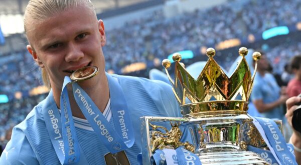 Manchester City's Norwegian striker #09 Erling Haaland poses with the Premier League trophy after the presentation ceremony following the English Premier League football match between Manchester City and West Ham United at the Etihad Stadium in Manchester, north west England, on May 19, 2024. Manchester City created English football history on Sunday, beating West Ham 3-1 to win an unprecedented fourth straight Premier League title.,Image: 874538388, License: Rights-managed, Restrictions: RESTRICTED TO EDITORIAL USE. No use with unauthorized audio, video, data, fixture lists, club/league logos or 'live' services. Online in-match use limited to 120 images. An additional 40 images may be used in extra time. No video emulation. Social media in-match use limited to 120 images. An additional 40 images may be used in extra time. No use in betting publications, games or single club/league/player publications., Model Release: no, Credit line: Oli SCARFF / AFP / Profimedia