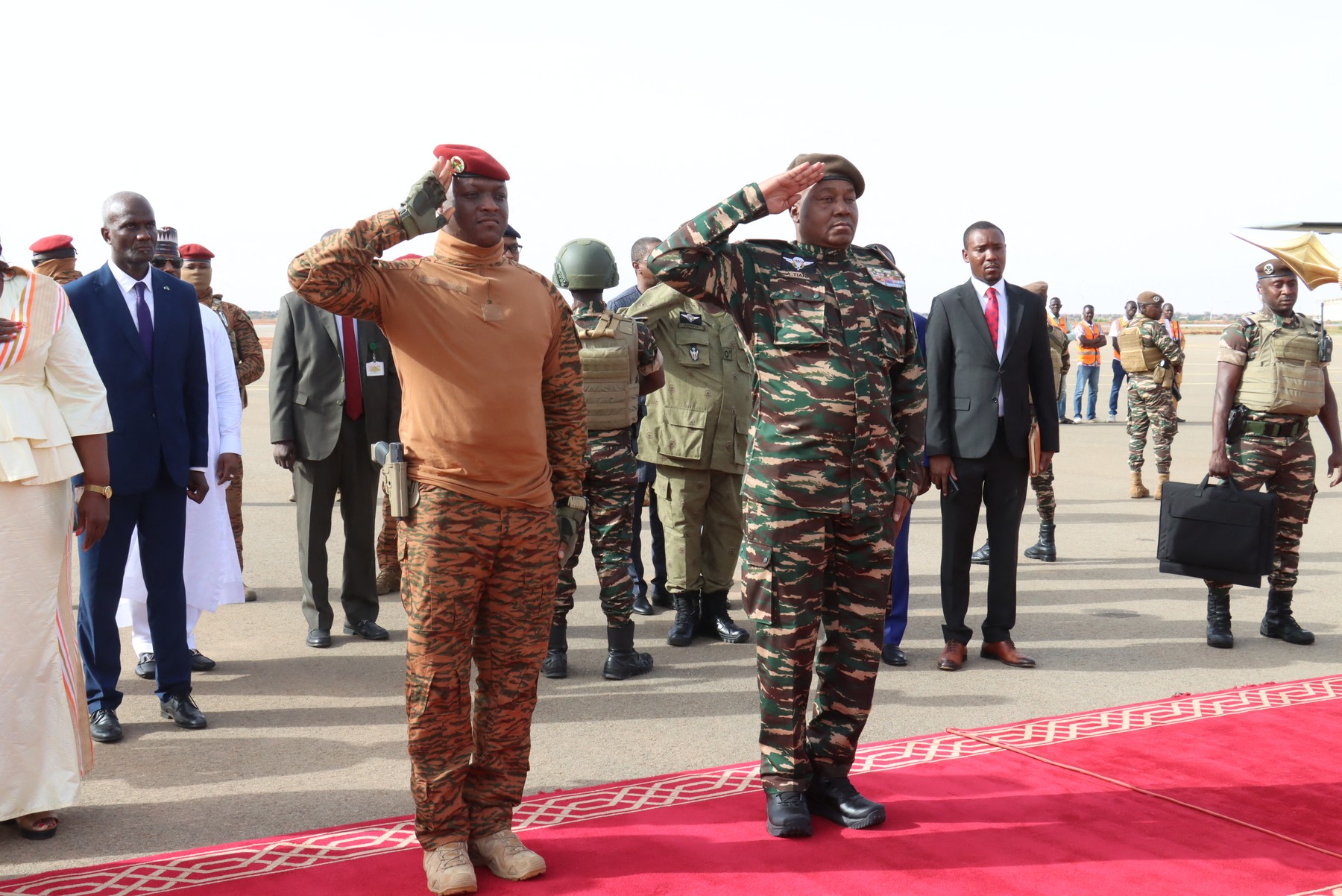 Niger's General Abdourahamane Tiani (R) salutes next to his Burkinabe counterpart Captain Ibrahim Traore (L) upon his arrival in Niamey on July 5, 2024. A divided West Africa  hosts two presidential summits this weekend -- one in Niger between Sahel region military regime leaders, followed by another in Nigeria on Sunday with leaders of a wider economic bloc. Saturday's summit in Niger's capital Niamey, will mark the first between the military leaders of a new regional bloc, the Alliance of Sahel States (AES). Mali, Burkina Faso and Niger set up the mutual defence pact in September, leaving the wider Economic Community of West African States (ECOWAS) bloc in January.,Image: 887665992, License: Rights-managed, Restrictions: , Model Release: no, Credit line: AFP / AFP / Profimedia