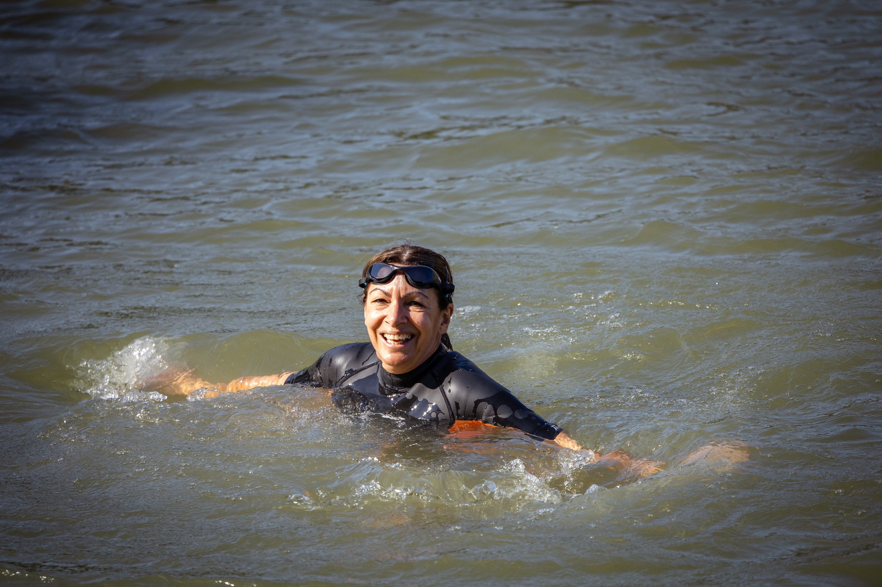 Paris Mayor Anne Hidalgo bathes and swims in a wetsuit and goggles in the Seine water at Bras Marie in Paris, France on July 17, 2024. Proof and swimming demonstration of the efforts made and spent by the City and the State to improve the quality of the water of the Seine, its bathability and the ecological state of the river which will host the open water swimming events during the Olympic and Paralympic Games JOP PARIS 2024.,Image: 890284341, License: Rights-managed, Restrictions: , Model Release: no, Credit line: Amaury Cornu / AFP / Profimedia