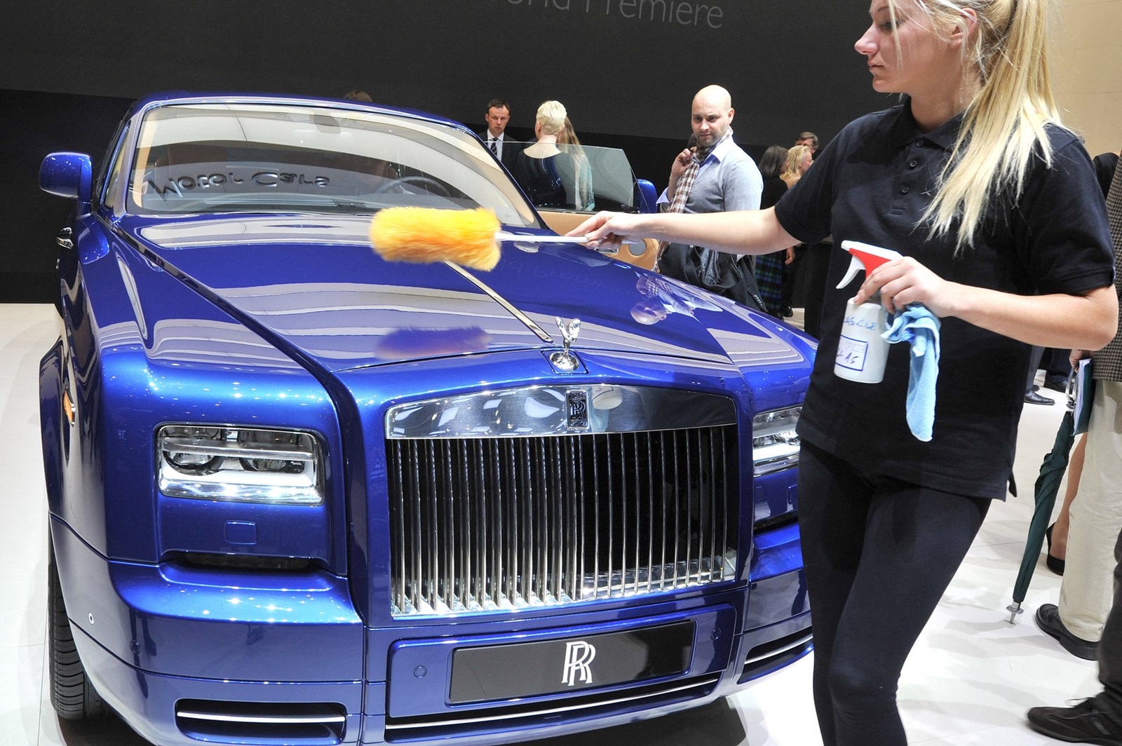 A Rolls Royce is cleaned at English car maker's booth  during a press day ahead of the 82nd Geneva Motor Show on March 6, 2012 in Geneva. Some 700 carmakers hold a press preview of their newest batch of automobiles at the Show, which opens to the public from March 8 to 18.,Image: 121010491, License: Rights-managed, Restrictions: , Model Release: no, Credit line: SEBASTIEN FEVAL / AFP / Profimedia