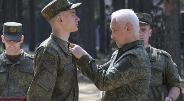 epa11497021 A handout photo made available by the Russian Defence Ministry Press-Service shows Russian Defense Minister Andrei Belousov (R) awarding a serviceman during his inspection of the organization of combat training of military personnel at a training ground of the Leningrad Military District in St. Petersburg, Russia, 26 July 2024.  EPA/RUSSIAN DEFENCE MINISTRY PRESS SERVICE HANDOUT -- MANDATORY CREDIT -- HANDOUT EDITORIAL USE ONLY/NO SALES