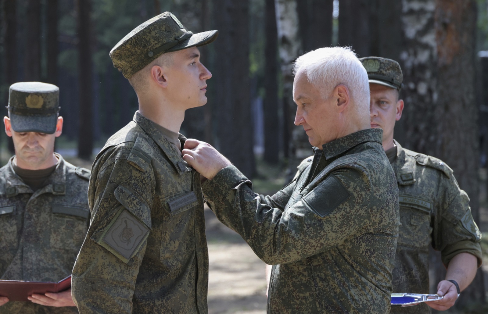 epa11497021 A handout photo made available by the Russian Defence Ministry Press-Service shows Russian Defense Minister Andrei Belousov (R) awarding a serviceman during his inspection of the organization of combat training of military personnel at a training ground of the Leningrad Military District in St. Petersburg, Russia, 26 July 2024.  EPA/RUSSIAN DEFENCE MINISTRY PRESS SERVICE HANDOUT -- MANDATORY CREDIT -- HANDOUT EDITORIAL USE ONLY/NO SALES