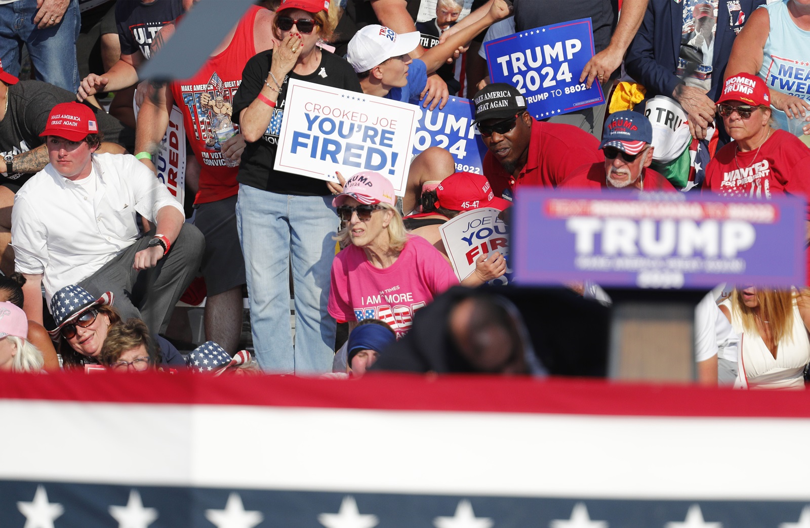 epa11476761 Supporters look on as former US President Donald Trump is rushed off stage by secret service after an incident during a campaign rally at the Butler Farm Show Inc. in Butler, Pennsylvania, USA, 13 July 2024. According to a statement by a  secret service spokesperson 'the former President is safe' and further information on the incident will be released when available.  EPA/DAVID MAXWELL