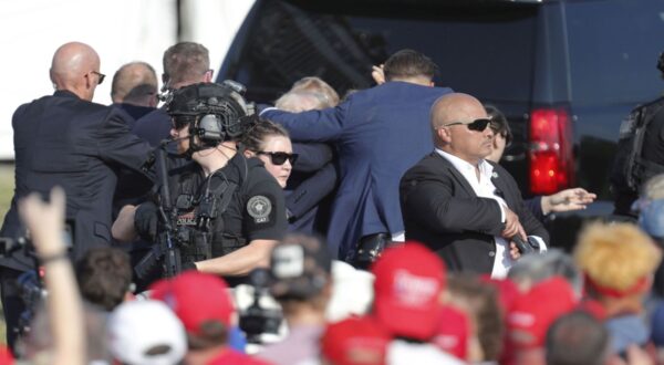 epa11476798 Former US President Donald Trump is rushed from stage by secret service after an incident during a campaign rally at the Butler Farm Show Inc. in Butler, Pennsylvania, USA, 13 July 2024. Trump was rushed off stage by secret service after an incident during a campaign rally in Pennsylvania. According to the Butler County district attorney a suspected gunman was dead and at least one rally attendee was killed. According to a statement by a secret service spokesperson, the former President is safe and further information on the incident will be released when available.  EPA/DAVID MAXWELL