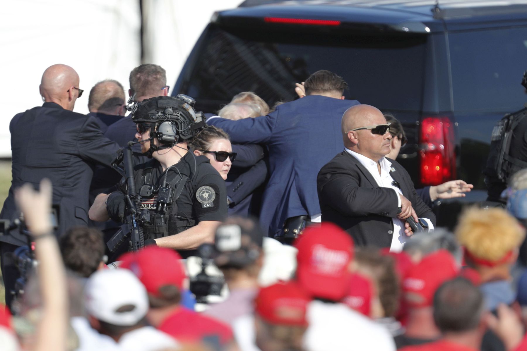 epa11476798 Former US President Donald Trump is rushed from stage by secret service after an incident during a campaign rally at the Butler Farm Show Inc. in Butler, Pennsylvania, USA, 13 July 2024. Trump was rushed off stage by secret service after an incident during a campaign rally in Pennsylvania. According to the Butler County district attorney a suspected gunman was dead and at least one rally attendee was killed. According to a statement by a secret service spokesperson, the former President is safe and further information on the incident will be released when available.  EPA/DAVID MAXWELL