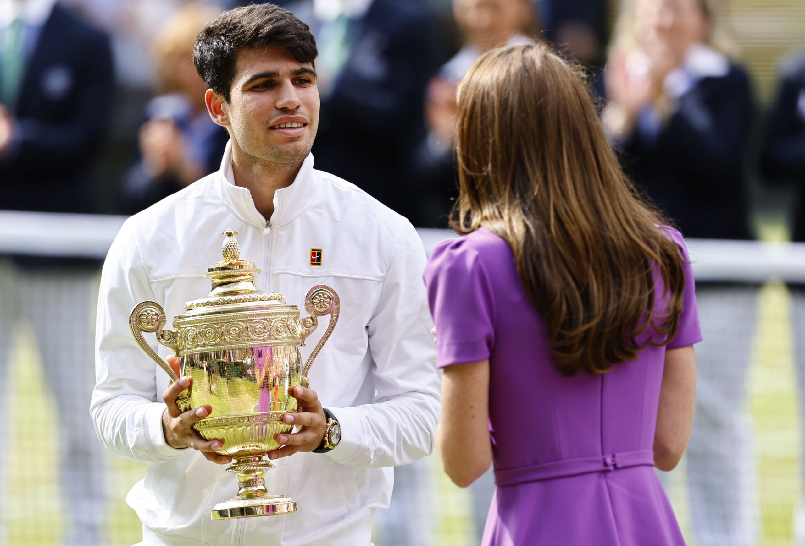 epa11477822 Carlos Alcaraz of Spain receives the trophy from Britain's Catherine, Princess of Wales after winning the Men's final against Novak Djokovic of Serbia at the Wimbledon Championships, Wimbledon, Britain, 14 July 2024.  EPA/TOLGA AKMEN  EDITORIAL USE ONLY