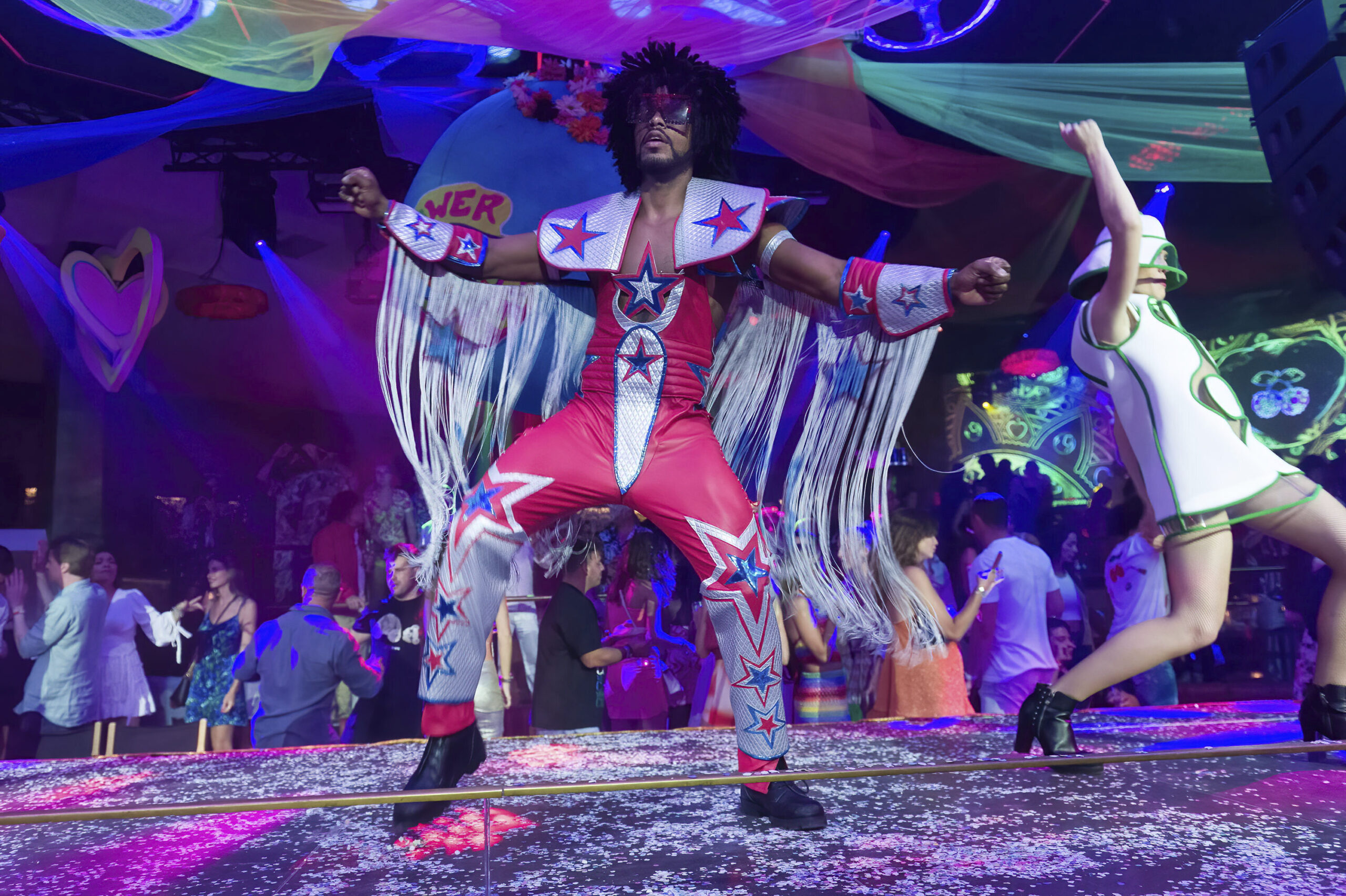 Two dancers at the Flower Power party at Pacha Ibiza nightclub, on June 7, 2022, in Ibiza, Balearic Islands (Spain). The Flower Power party has been held at the legendary Pacha Ibiza nightclub for four decades with a colorful proposal that perfectly captures the essence of the most hippie Ibiza. The event offers a soundtrack based on great classics of rock, soul, funk and pop of the 60's, 70's and 80's with a creative and colorful decoration. In addition, the audience usually dresses in bell-bottoms, flowers in their hair, wigs and colorful dresses. The party has been held every Monday since May 23, after the island's nightlife reopened after two years of inactivity due to the pandemic. FLOWER POWER;PACHA;DISCO Germán Lama / Europa Press 06/07/2022 (Europa Press via AP)