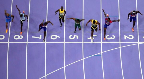 Noah Lyles, of the United States, in lane seven, wins the men's 100-meter final at the 2024 Summer Olympics