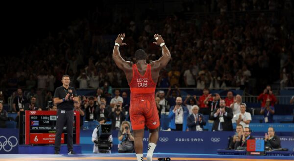 Cuba's LOPEZ NUNEZ Mijain leaves his shoes on a mat after winning the Men's Greco-Roman 130kg Final against Chile's ACOSTA FERNANDEZ Yasmani in the Paris Olympics at the Paris Olympics at the Champ de Mars Arena