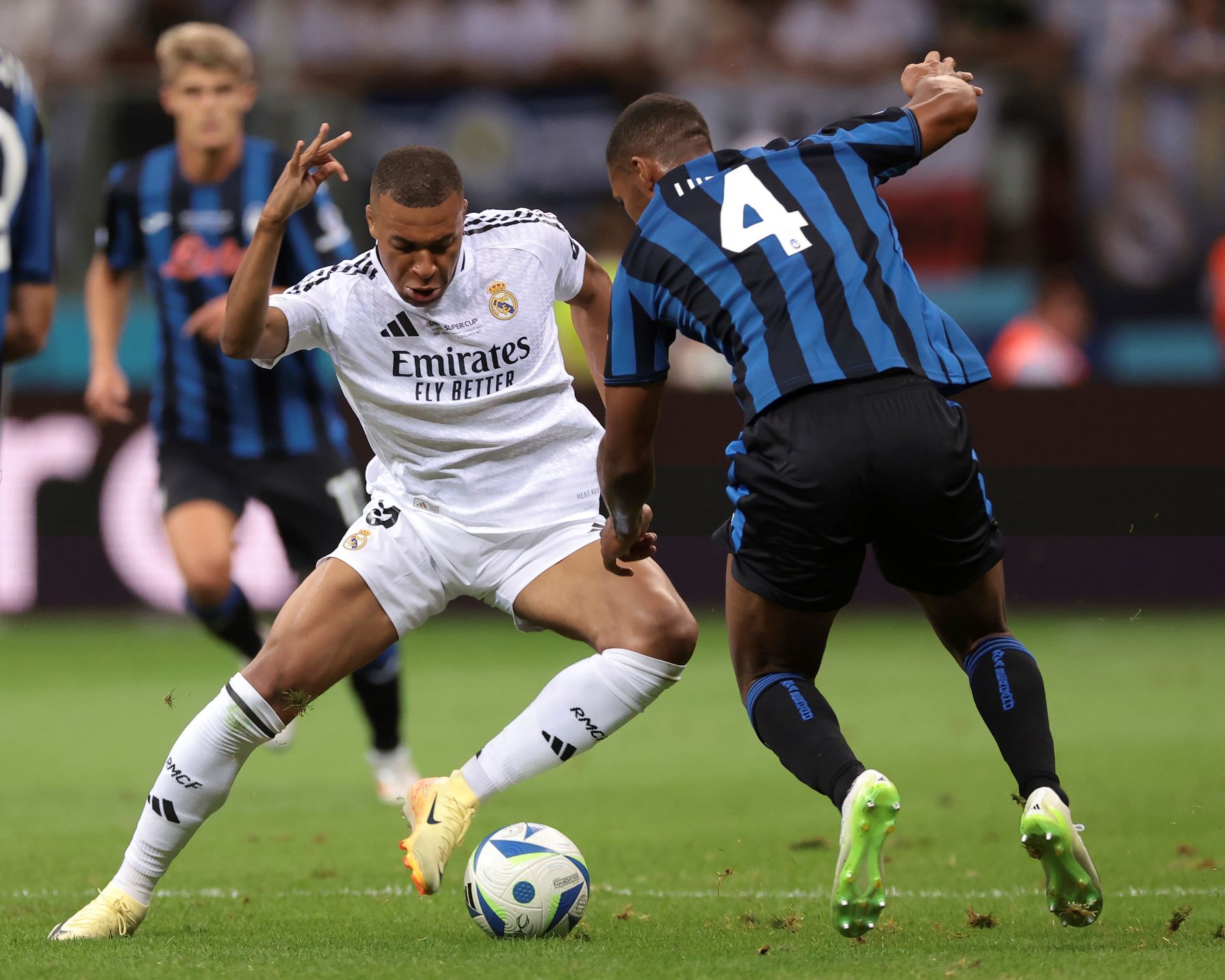 Warsaw: Warsaw, Poland, 14th August 2024. Kylian Mbappe of Real Madrid takes on Isak Hien of Atalanta during the UEFA Super Cup match at National Stadium, Warsaw