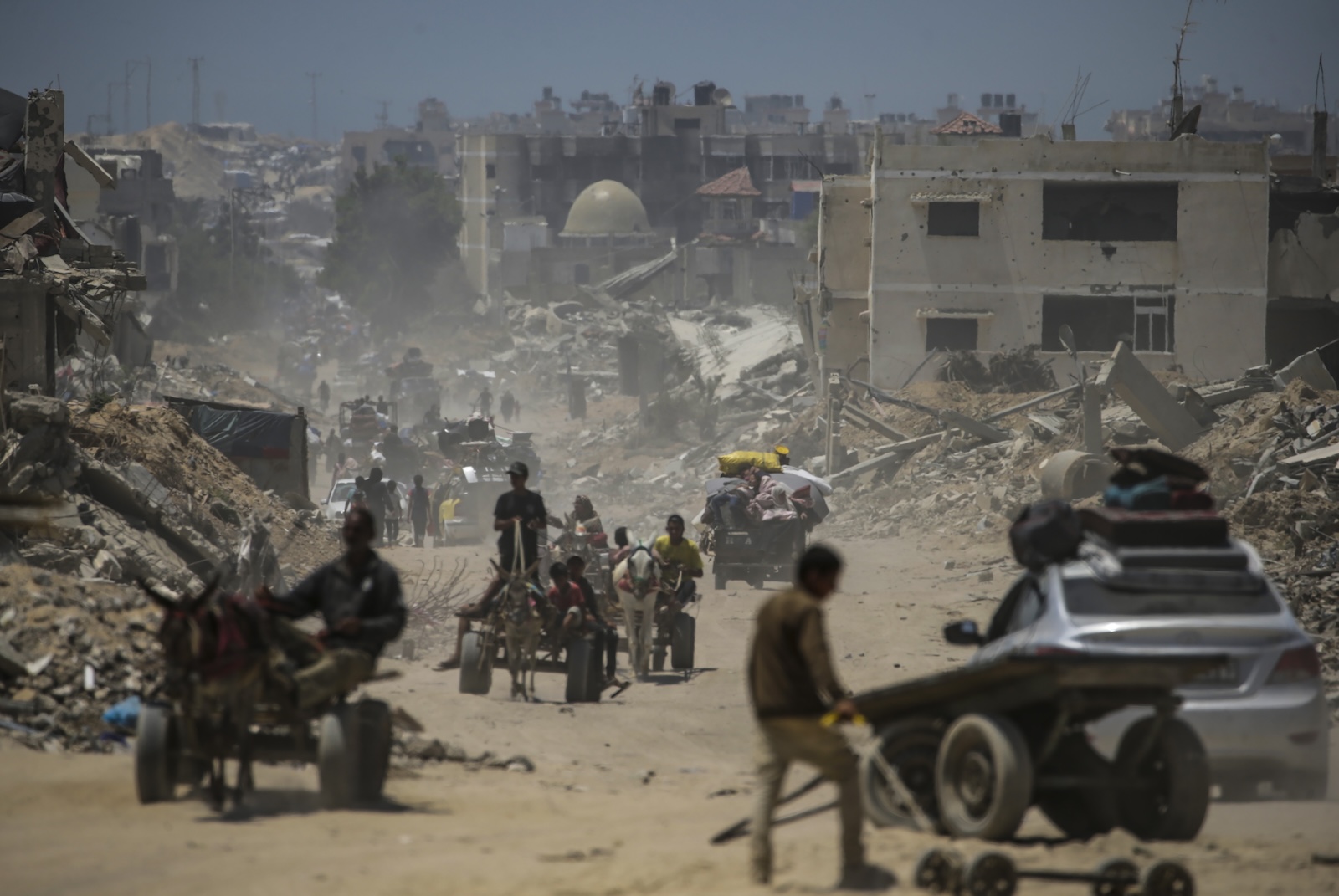 epa11453013 Internally displaced Palestinians leave with their belongings following an evacuation order issued by the Israeli army, in Khan Younis, southern Gaza Strip, 02 July 2024. More than 37,000 Palestinians and over 1,455 Israelis have been killed, according to the Palestinian Health Ministry and the IDF, since Hamas militants launched an attack against Israel from the Gaza Strip on 07 October 2023, and the Israeli operations in Gaza and the West Bank which followed it.  EPA/MOHAMMED SABER