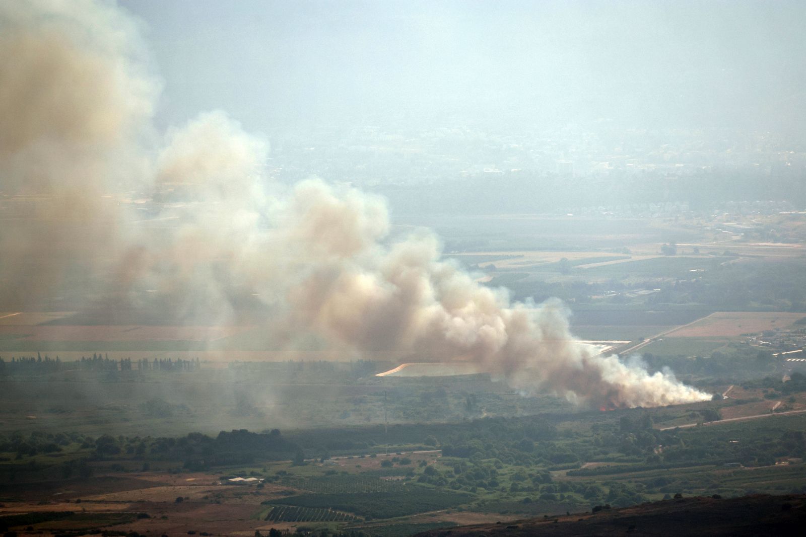 epa11509218 Smoke rises as a result of a missile fired from south Lebanon, in Keppotz HaGoshrim in the Upper Galilee, northern Israel, 30 July 2024. The Israeli army reported that approximately 10 projectiles crossed from Lebanon into Israeli territory, the majority were intercepted. A hit was identified in the area of HaGoshrim in northern Israel. Reports were received regarding a civilian that was injured as a result of the attack.  EPA/ATEF SAFADI