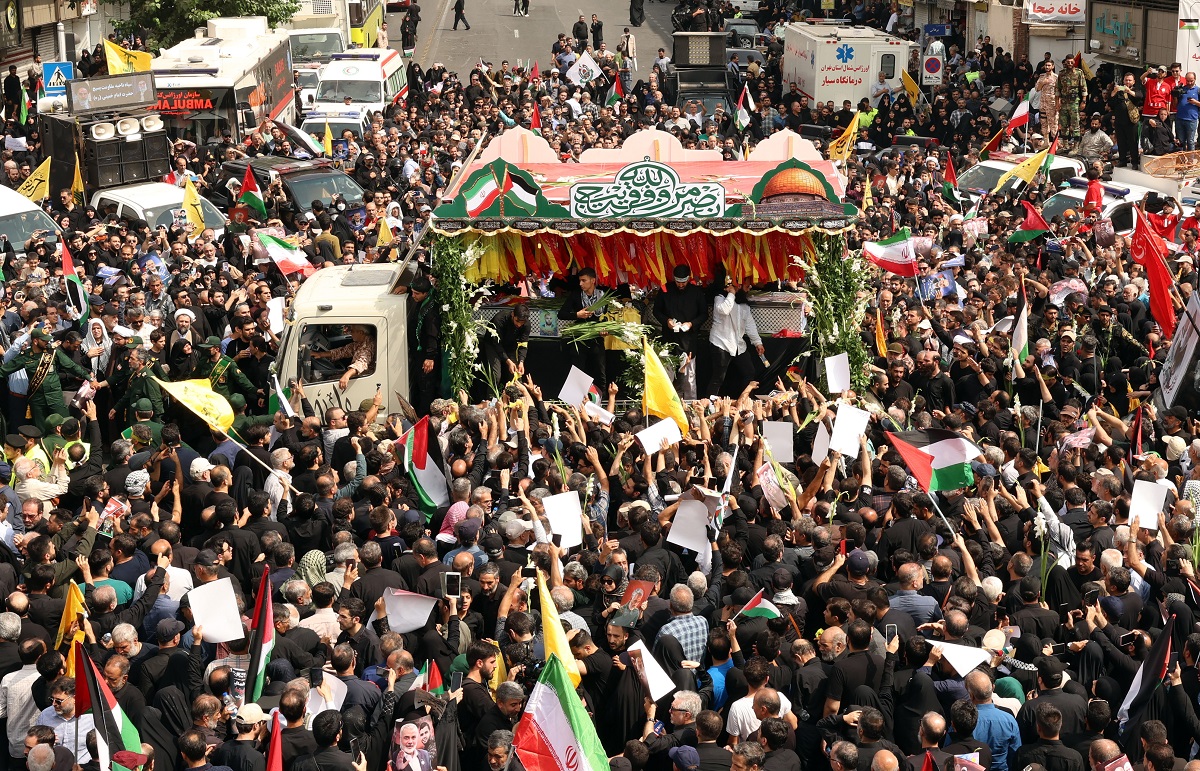 epa11514215 People gather as the coffins of Hamas late political leader Ismail Haniyeh and his bodyguard are carried on the back of a truck during a funeral procession in Tehran, Iran, 01 August 2024. Haniyeh and one of his bodyguards were targeted and killed in Tehran on 31 July 2024, the Iranian Revolutionary Guard Corps (IRGC) confirmed.  EPA/ABEDIN TAHERKENAREH