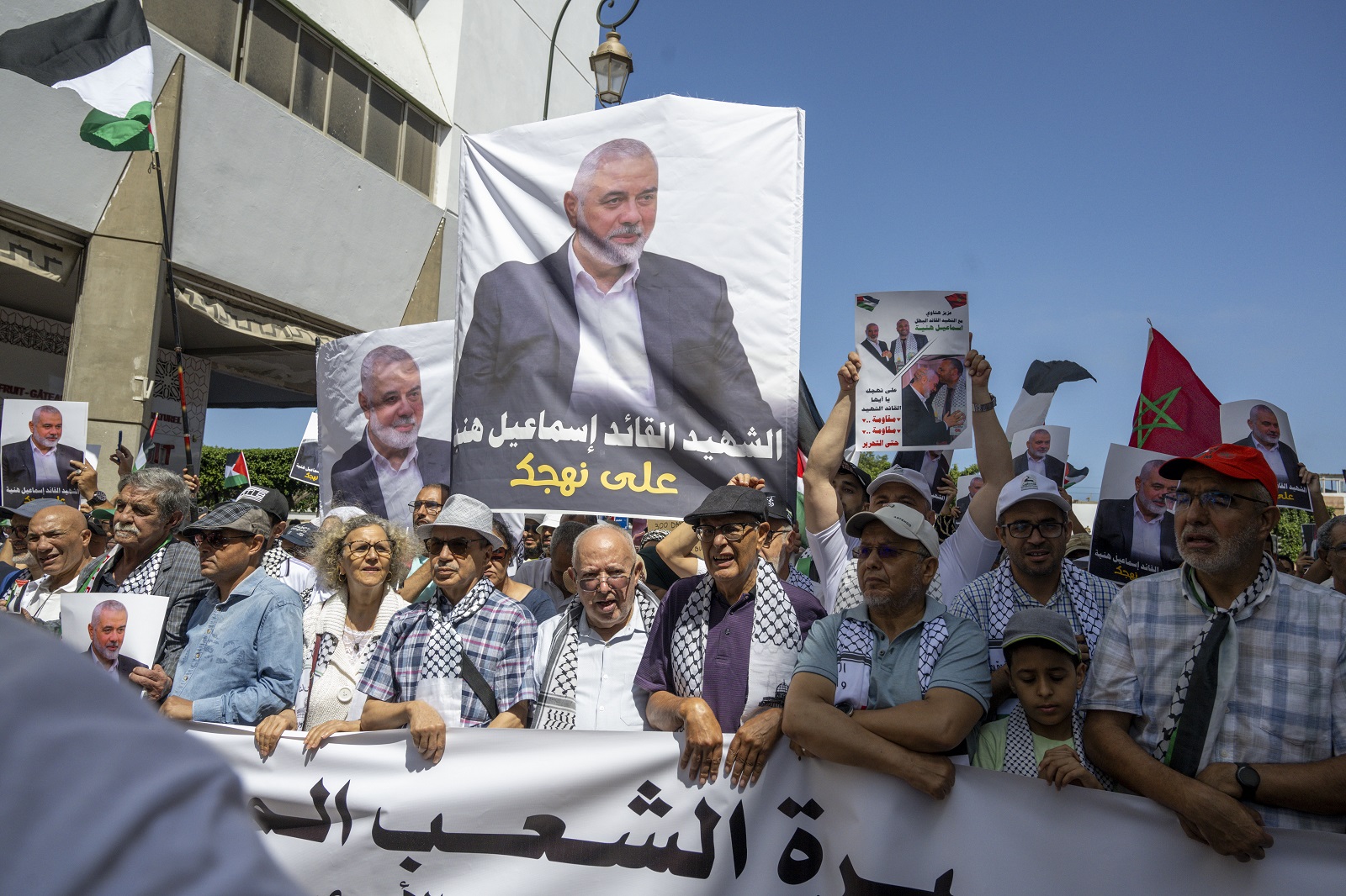 epa11522487 Demonstrators carry placards with pictures of Palestinian Hamas political leader Ismail Haniyeh during a rally in Rabat, Morocco, protesting the killing of Hamas political leader Haniyeh, 03 August 2024. Haniyeh and one of his bodyguards were targeted and killed in Tehran, Iran, on 31 July 2024, the Iranian Revolutionary Guard Corps (IRGC) confirmed.  EPA/JALAL MORCHIDI