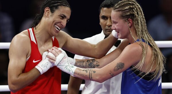 epa11522795 Imane Khelif of Algeria (red) and Anna Luca Hamori of Hungary (blue) hug in their Women 66kg Quarterfinal bout of the Boxing competitions in the Paris 2024 Olympic Games, at the North Paris Arena in Villepinte, France, 03 August 2024.  EPA/Miguel Tona