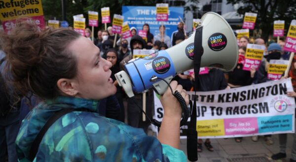 epa11534966 An anti-racist protester speaks through a megaphone in Brentford, west London,  Britain, 07 August 2024.  Further far-right protests are expected throughout Britain on the 07 August 2024. Violent demonstrations have been held by members of far-right groups across Britain following a fatal stabbing attack in Southport, in which three children were killed and eight more seriously injured along with two adults.  EPA/NEIL HALL