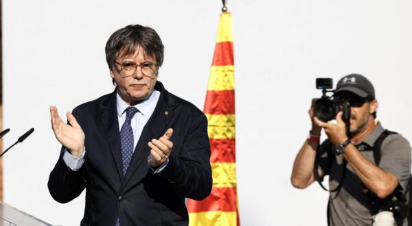 epa11535505 Former Catalan president Carles Puigdemont (L) gestures as he addresses supporters in Barcelona, Spain, 08 August 2024. Catalonia's former president Carles Puigdemont returned to Spain after seven years of self-imposed exile abroad, despite a pending arrest warrant. The Mossos d'Esquadra was deployed early morning on 08 August to secure access to the Parliament for the investiture of Salvador Illa. The plenary session of the Parliament will host the investiture debate of the Socialist leader Salvador Illa as the new president of the Generalitat, the government of Catalonia.  EPA/ALBERTO ESTEVEZ