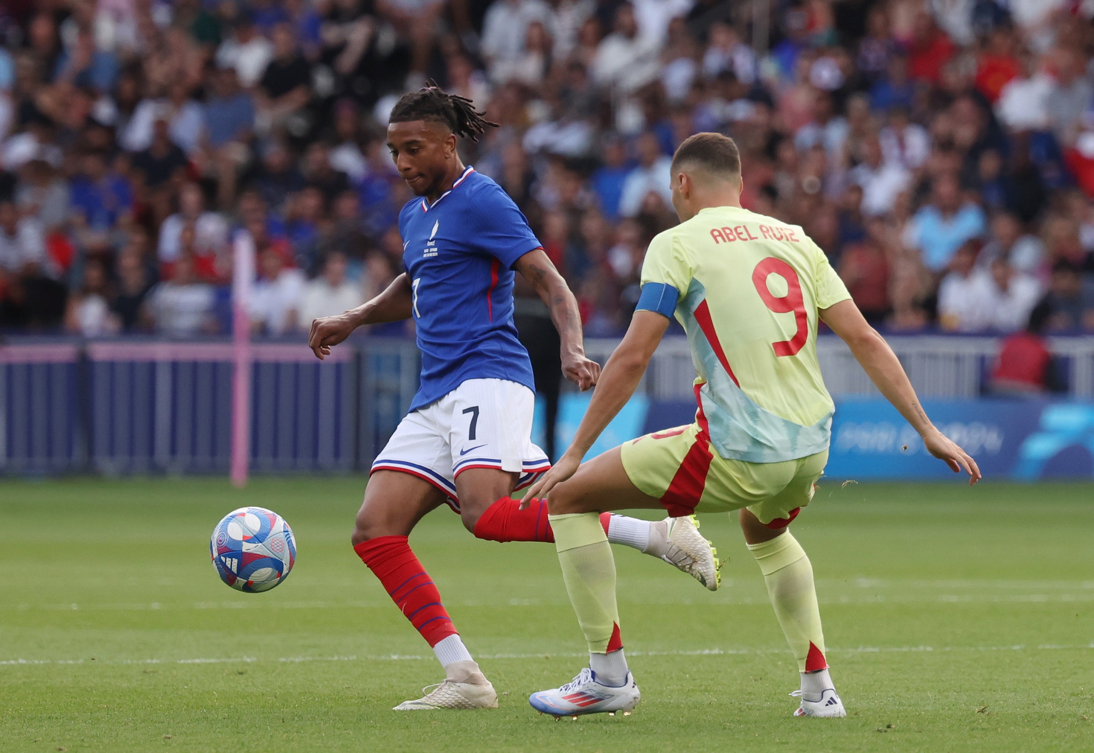 epa11540278 Manu Kone of France (L) in action against Abel Ruiz of Spain during the Gold medal match between France and Spain, of the Soccer competitions in the Paris 2024 Olympic Games, at the Parc des Princes stadium in Paris, France, 09 August 2024.  EPA/MOHAMMED BADRA