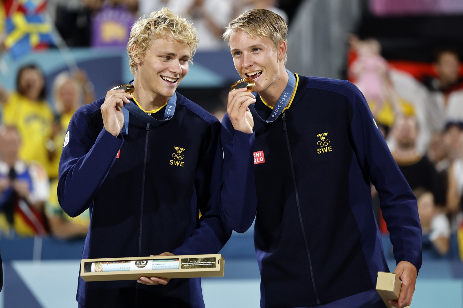 epa11544343 Gold medallists David Ahman and Jonatan Hellvig of Sweden pose during the Men's medals ceremony of the Beach Volleyball competitions in the Paris 2024 Olympic Games, at the Eiffel Tower in Paris, France, 10 August 2024.  EPA/TOLGA AKMEN