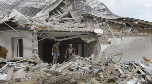 epa11545322 Locals clear debris following a rocket strike on a private building in a village near Brovary, Kyiv region, Ukraine, 11 August 2024, amid the Russian invasion. A man and his four-year-old son were killed while three other people were injured in an overnight Russian missile strike, the State Emergency Service of Ukraine said on 11 August.  EPA/SERGEY DOLZHENKO 59898