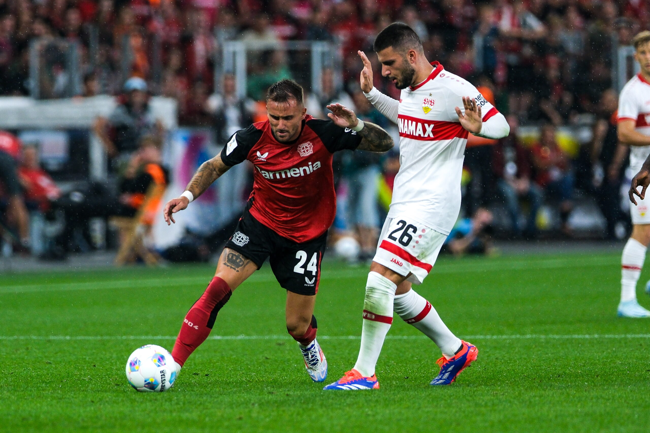 epa11553547 Leverkusen’s Aleix Garcia in action against Stuttgart's Deniz Undav (R) during the German Super Cup soccer match between Bayer 04 Leverkusen and VfB Stuttgart in Leverkusen, Germany, 17 August 2024.  EPA/FLORIAN WIEGAND CONDITIONS - ATTENTION: The DFL regulations prohibit any use of photographs as image sequences and/or quasi-video.