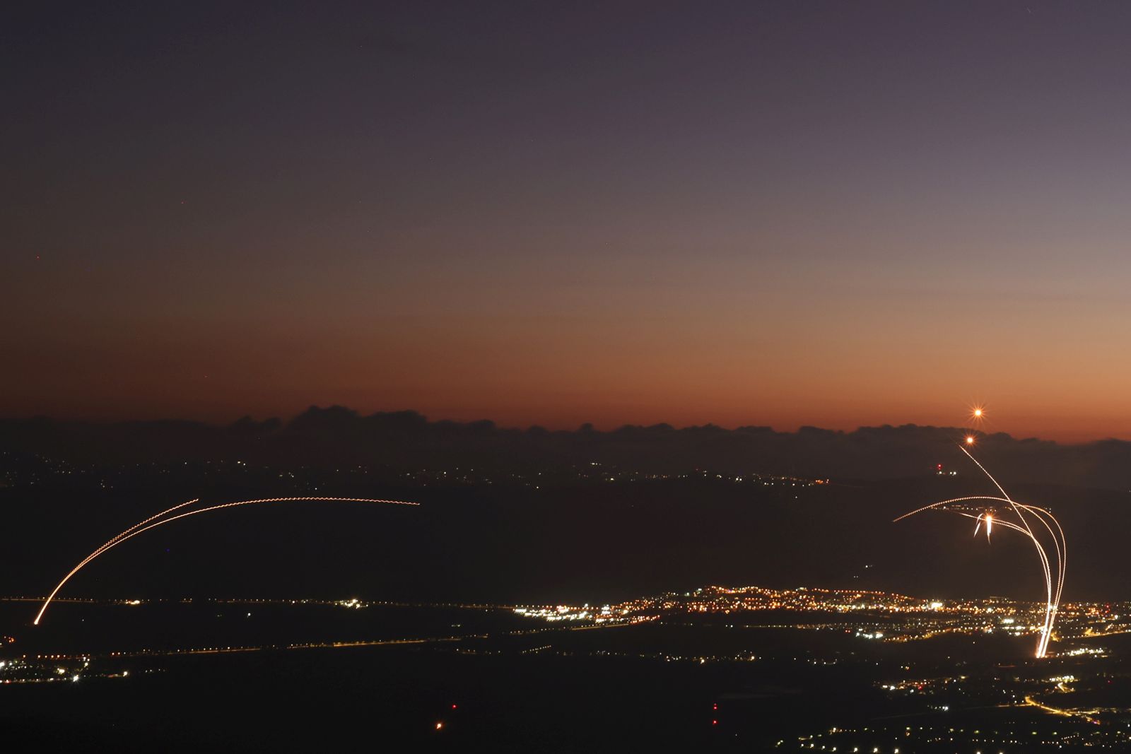 epa11561885 Israel's Iron Dome air defense system intercepts projectiles fired from southern Lebanon over the Upper Galilee in northern Israel, 23 August 2024. The Israeli military stated that a number of projectiles fired from Lebanese territory were identified crossing into northern Israel, with most of the projectiles falling in open areas in the Upper Galilee.  EPA/ATEF SAFADI