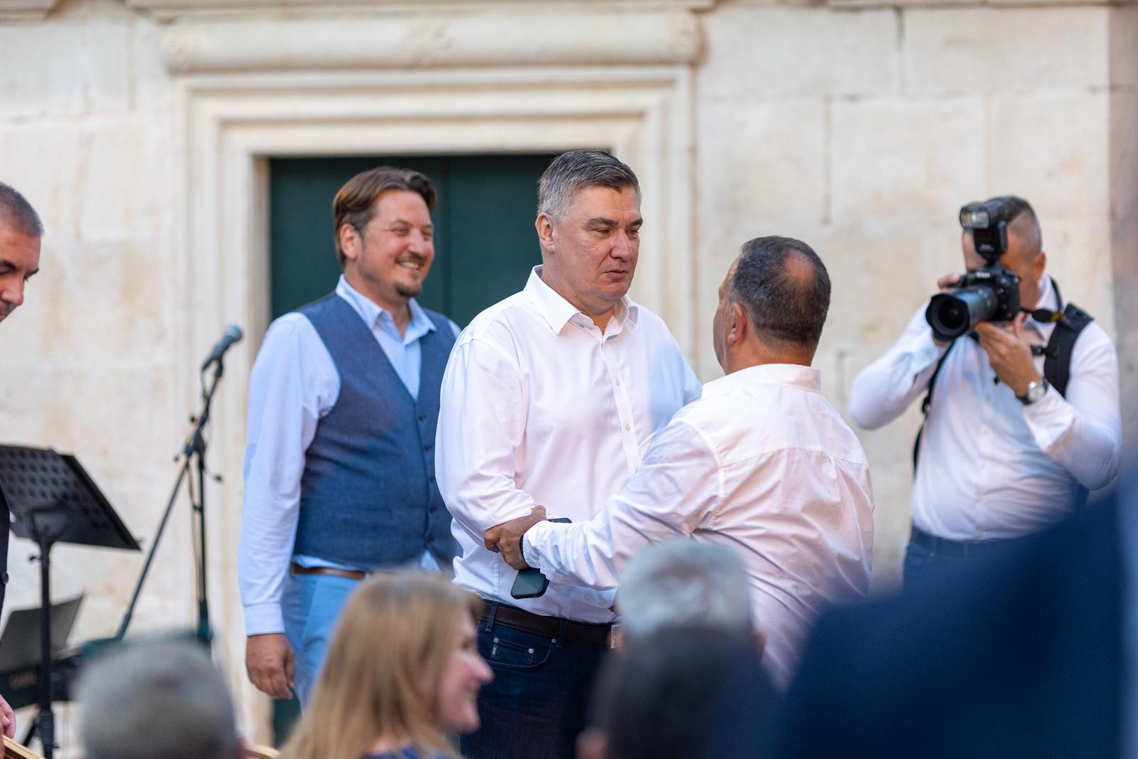 14.08.2024., Jelsa - Predsjednik Republike Hrvatske Zoran Milanovic nazocio je svecanoj sjednici Opcine Jelsa na trgu Sv. Ivana. Vili Beros, Zoran Milanovic. Photo: Nikola Radovani/PIXSELL