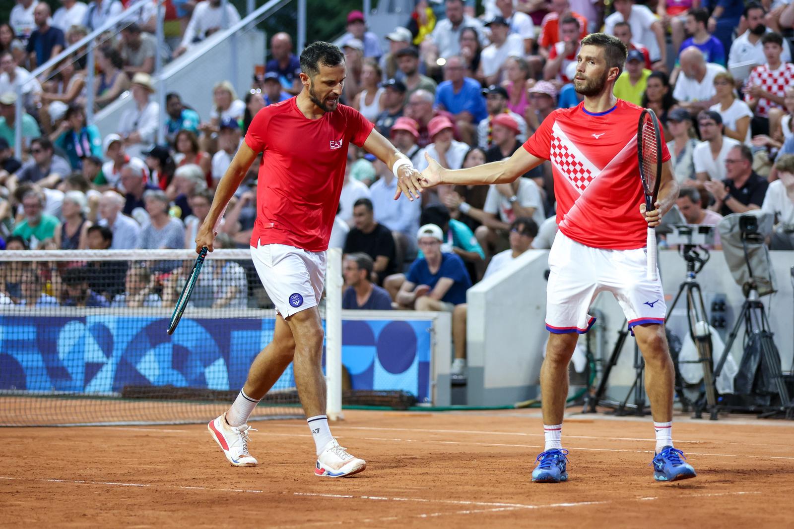 29.07.2024., Pariz, Francuska - XXXIII. Olimpijske igre Pariz 2024. Tenis. Mec 1. kola muskih parova izmedju Nikole Mektica i Mate Pavica (Hrvatska) protiv Jana Lennarda Struffa i Dominika Koefpera (Njemacka). Mate Pavic, Nikola Mektic Photo: Igor Kralj/PIXSELL