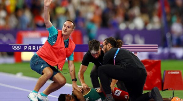 Paris 2024 Olympics - Athletics - Men's 3000m Steeplechase Final - Stade de France, Saint-Denis, France - August 07, 2024. Lamecha Girma of Ethiopia is tended to by medical staff during the Steeplechase final. REUTERS/Stephanie Lecocq Photo: STEPHANIE LECOCQ/REUTERS