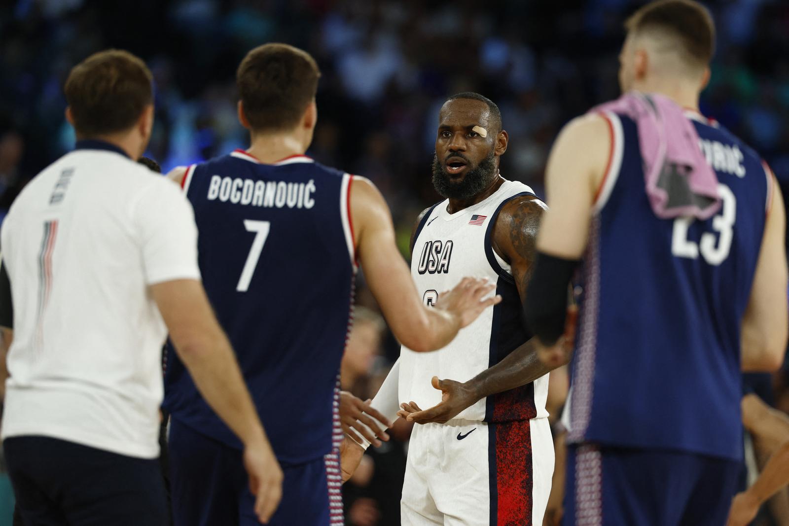 Paris 2024 Olympics - Basketball - Men's Semifinal - United States vs Serbia - Bercy Arena, Paris, France - August 08, 2024. Lebron James of United States and Bogdan Bogdanovic of Serbia react during the semifinal. REUTERS/Evelyn Hockstein Photo: Evelyn Hockstein/REUTERS