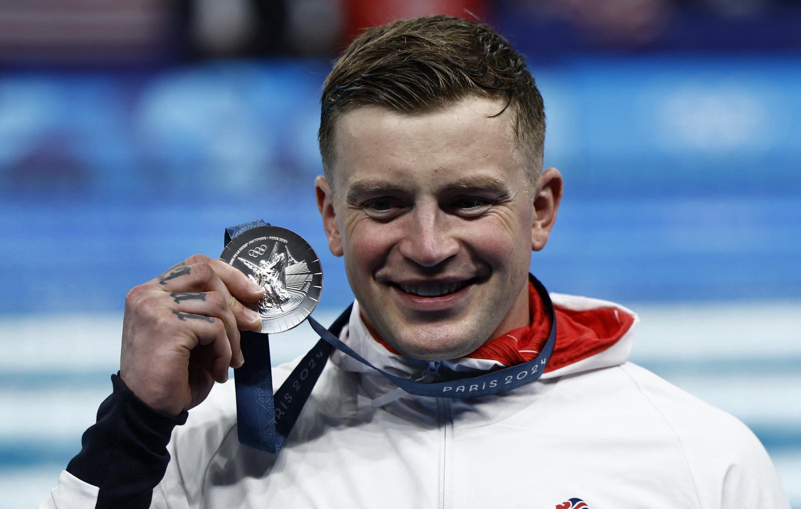 Paris 2024 Olympics - Swimming - Men's 100m Breaststroke Victory Ceremony - Paris La Defense Arena, Nanterre, France - July 28, 2024.  Silver medallist Adam Peaty of Britain celebrates. REUTERS/Clodagh Kilcoyne Photo: Clodagh Kilcoyne/REUTERS