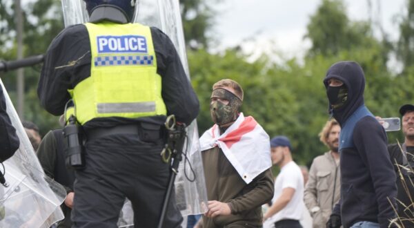 Police officers watch protesters during an anti-immigration demonstration outside the Holiday Inn Express in Rotherham, South Yorkshire. Picture date: Sunday August 4, 2024.,Image: 895898276, License: Rights-managed, Restrictions: , Model Release: no, Credit line: Danny Lawson / PA Images / Profimedia