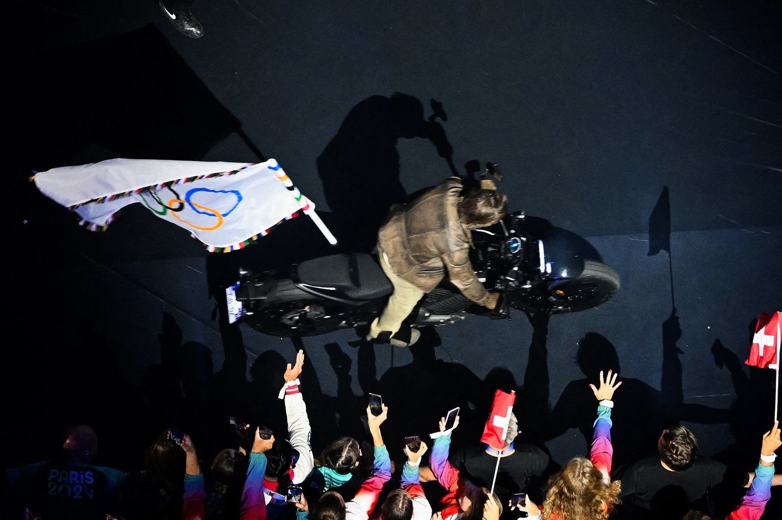 An overview shows US' actor Tom Cruise leaving the stadium with the Olympic flag on a motorbike during the closing ceremony of the Paris 2024 Olympic Games at the Stade de France, in Saint-Denis, in the outskirts of Paris, on August 11, 2024.,Image: 897884108, License: Rights-managed, Restrictions: , Model Release: no, Credit line: Julie SEBADELHA / AFP / Profimedia