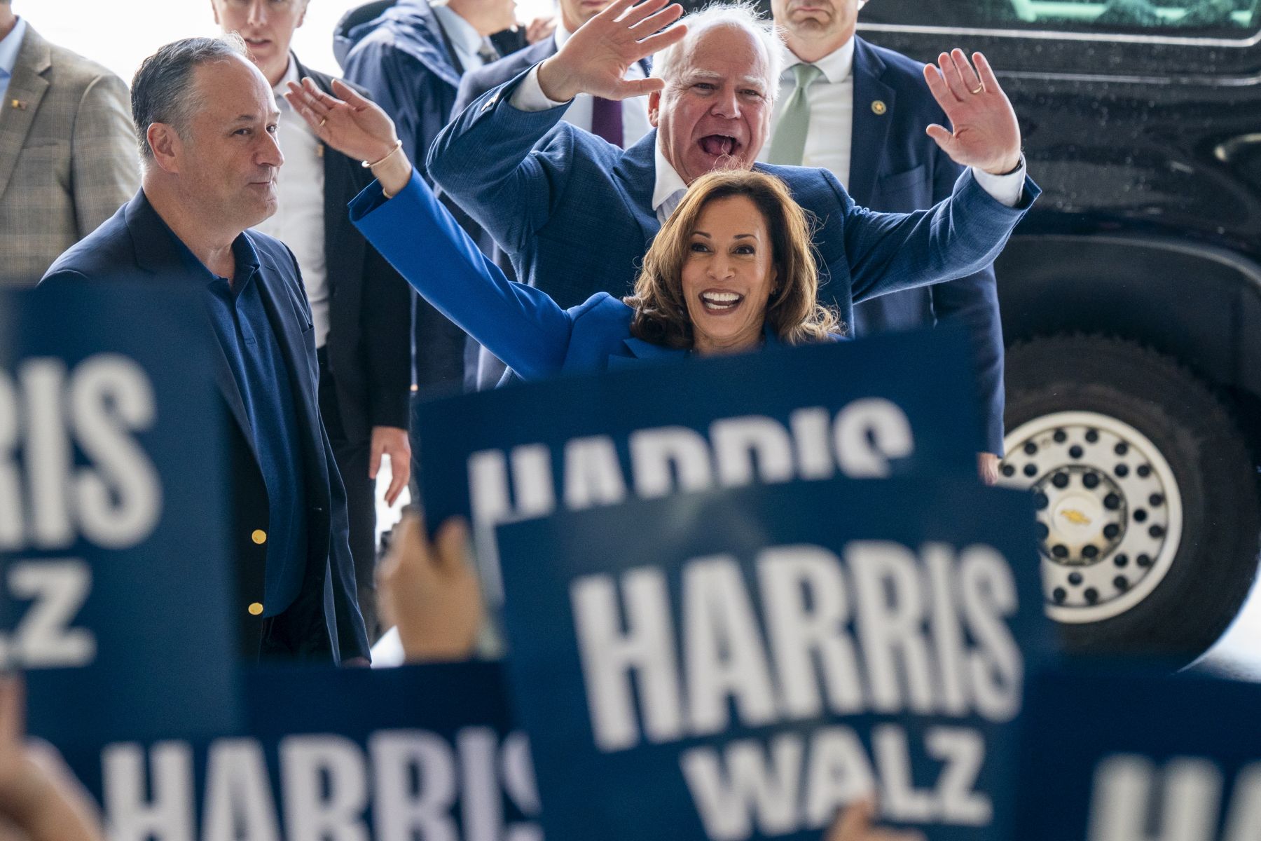 epa11554470 US Vice President and presumptive Democratic Presidential nominee Kamala Harris (R), her running mate Tim Walz (C) and Second Gentleman Doug Emhoff (L) greet supporters prior to a campaign bus tour at Pittsburgh International Airport in Pittsburgh, Pennsylvania, USA, 18 August 2024. A new CBS News national poll shows Vice President Harris with a narrow lead over former President Donald Trump.  EPA/SHAWN THEW