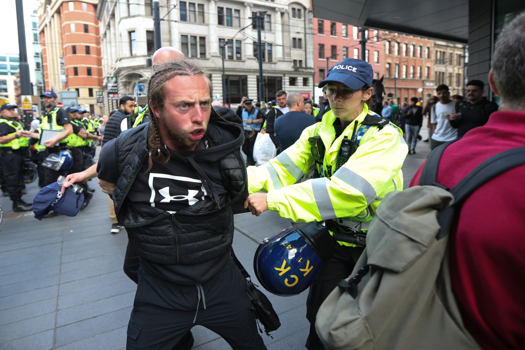 epa11521719 A protester is detained by police in Manchester, Britain, 03 August 2024. Violent demonstrations by members of far-right groups have sprung up across Britain in the aftermath of a fatal stabbing attack in Southport, in which three children were killed and eight more seriously injured along with two adults.  EPA/STR