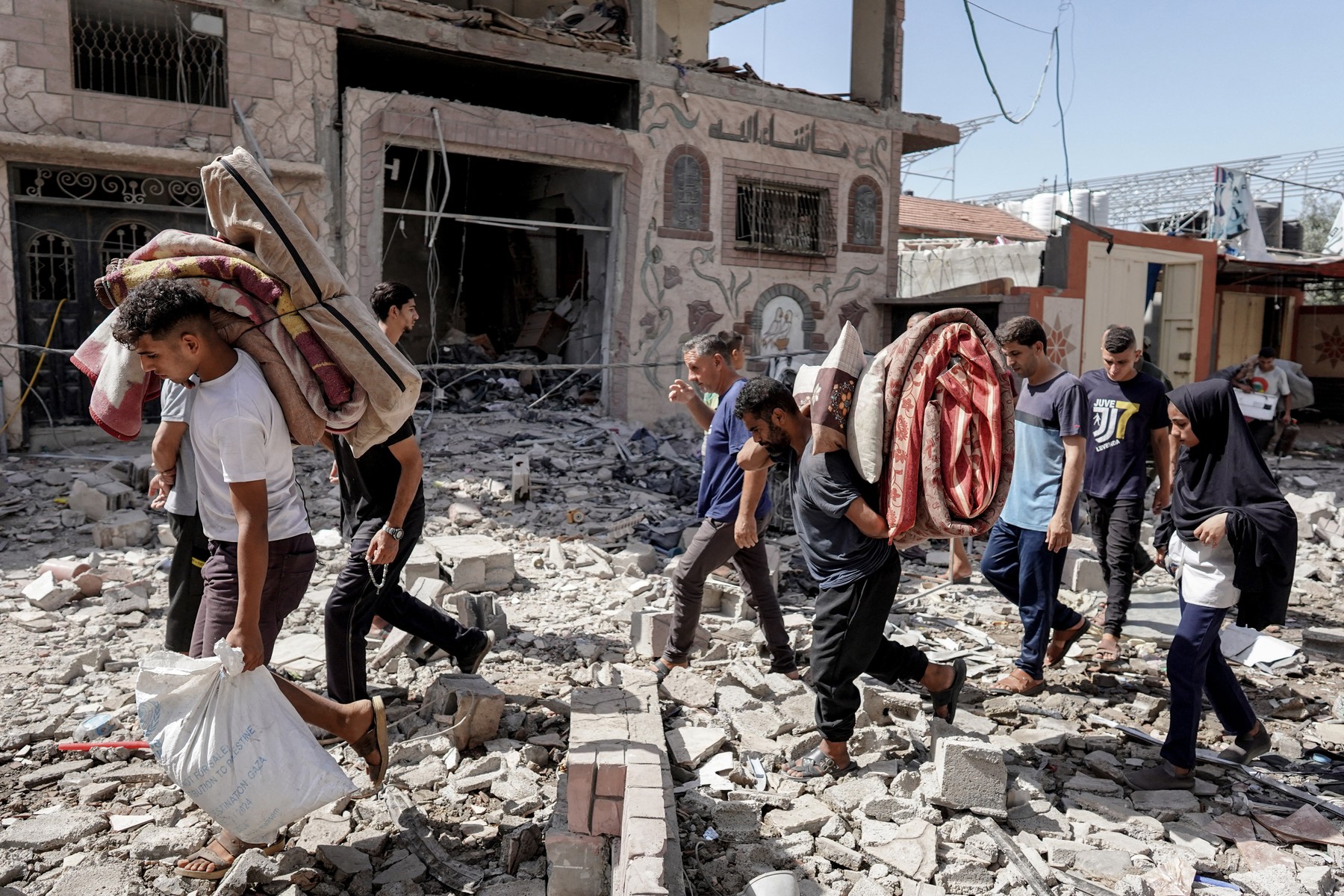 Palestinians evacuate with their belongings following an operation by the Israeli Special Forces in the Nuseirat camp, in the central Gaza Strip on June 8, 2024, amid the ongoing conflict between Israel and the Palestinian Hamas militant group.,Image: 879950959, License: Rights-managed, Restrictions: , Model Release: no, Credit line: Bashar TALEB / AFP / Profimedia