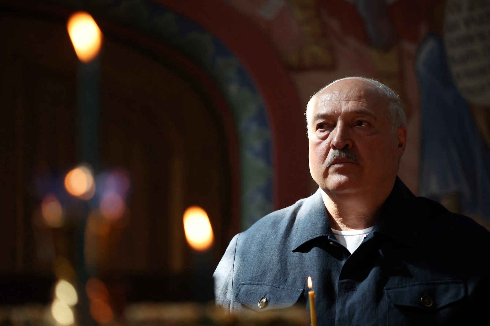 In this pool photograph distributed on July 26, 2024, by Russian state owned Sputnik agency Belarusian President Alexander Lukashenko holds a candle as he visits Valaam Monastery with the Russian President, in nothern Russia on July 25, 2024.,Image: 892564387, License: Rights-managed, Restrictions: Editor's note : this image is distributed by Russian state owned agency Sputnik, Model Release: no, Credit line: Alexander KAZAKOV / AFP / Profimedia