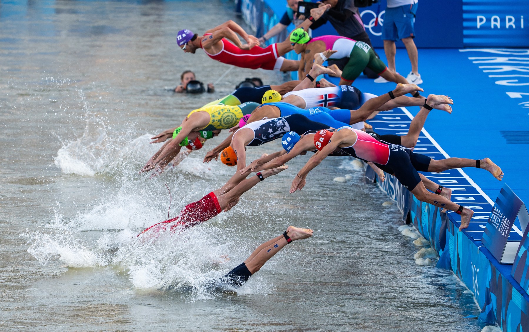 PARIS, FRANCE - AUGUST 05: Athletes dive to compete in the Mixed Relay on day ten of the Olympic Games Paris 2024 at Pont Alexandre III on August 05, 2024 in Paris, France. Aytac Unal / Anadolu,Image: 896130926, License: Rights-managed, Restrictions: , Model Release: no, Credit line: Aytac Unal / AFP / Profimedia